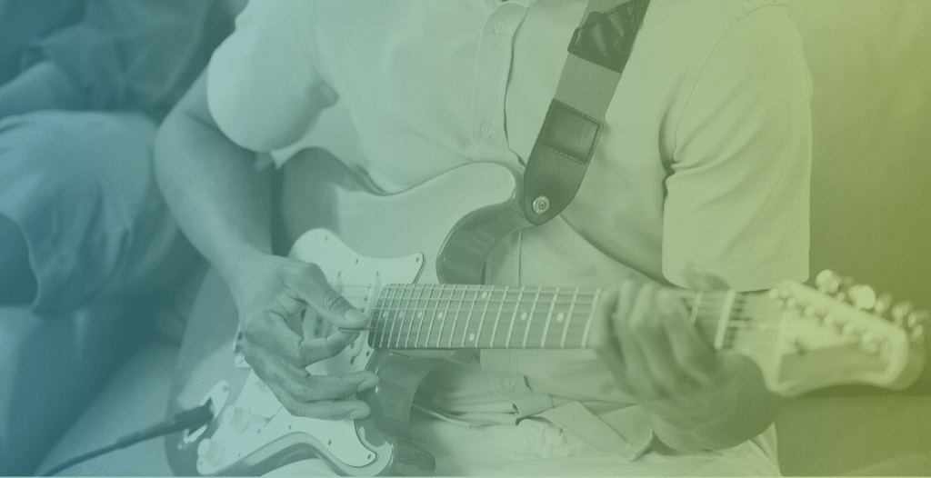 Close-up of a person playing an electric guitar.