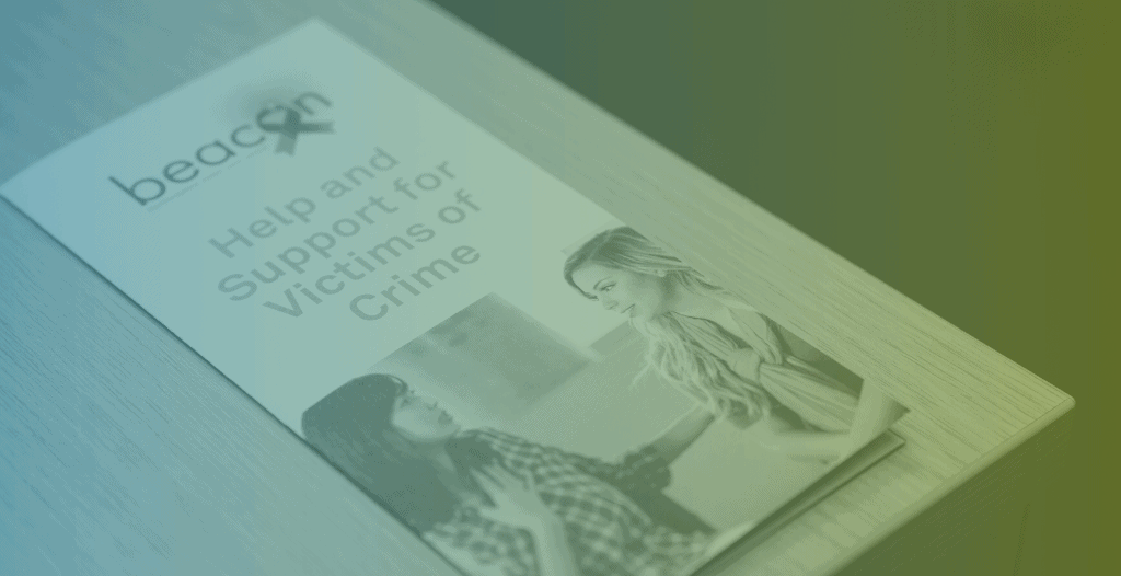 Close-up of a leaflet which reads "Beacon: Help and support for victims of crime"
