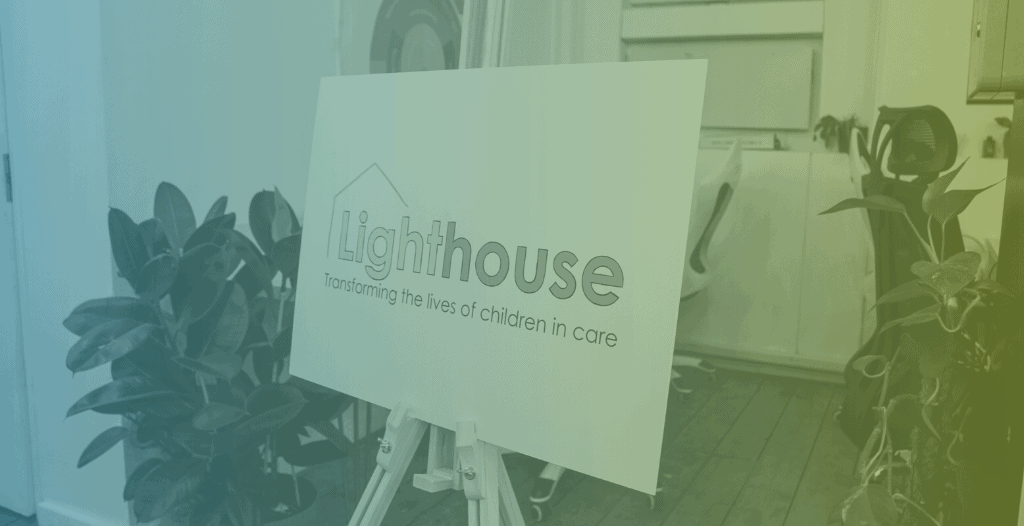 A sign on an easel with the Lighthouse logo.