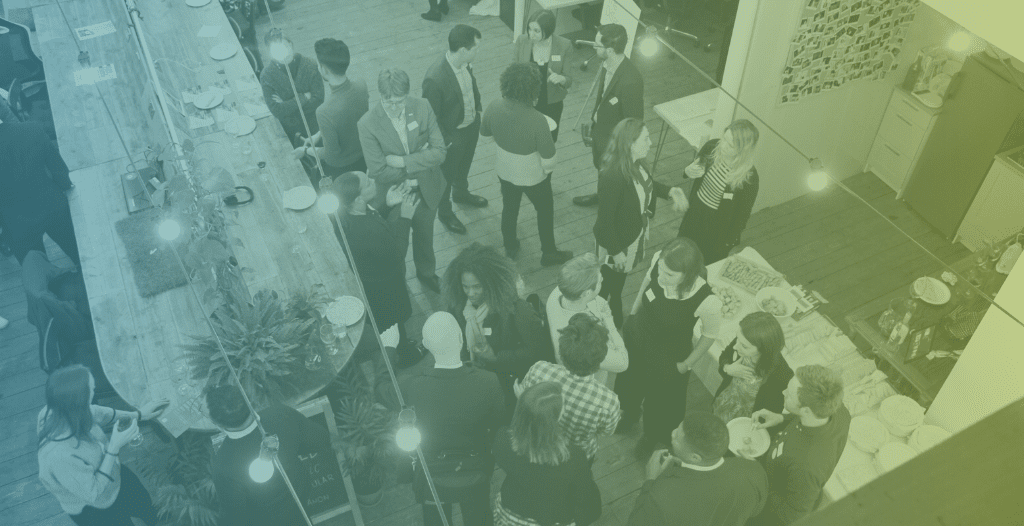 Overhead view of people networking at the Meet the Innovators event.