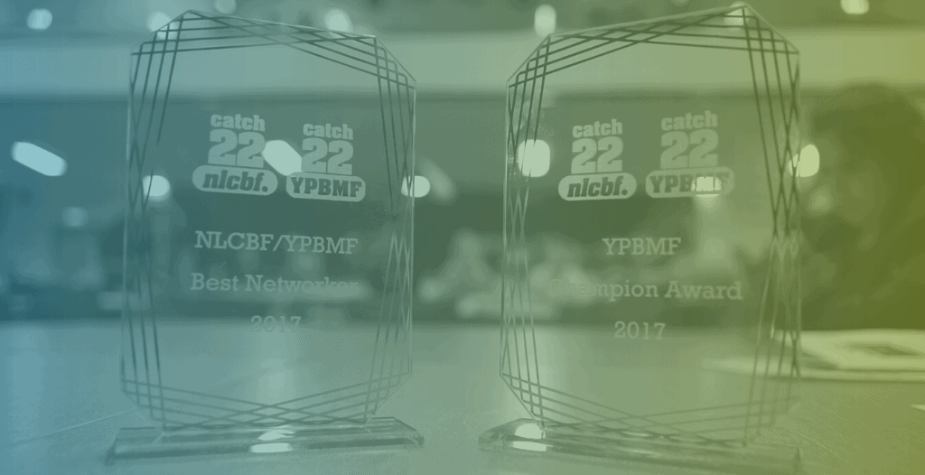 Close-up of two glass trophies with NLCBF and YPBMF branding on them. The first is for Best Networker 2017 and the second is for YPBMF Champion of the Year 2017.