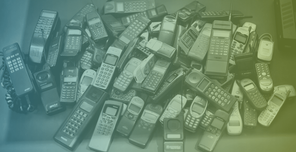 A colection of old mobile phone devices from the pre-smartphone era.