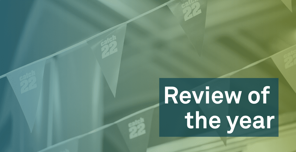 Catch22-branded bunting is hung from the ceiling. Overlaid is text that reads "Review of the Year".