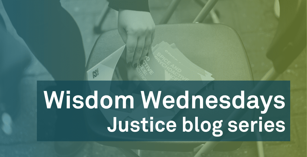A person picks up a Catch22 Justice booklet from a chair. Overlaid is text that reads: "Wisdom Wednesdays: Justice Blog Series".