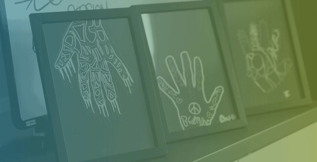 Artwork created by participants on the Wolverhampton Violence Reduction Service. The artwork was created by drawing around their hands and then filling in the space. The artwork has been framed.